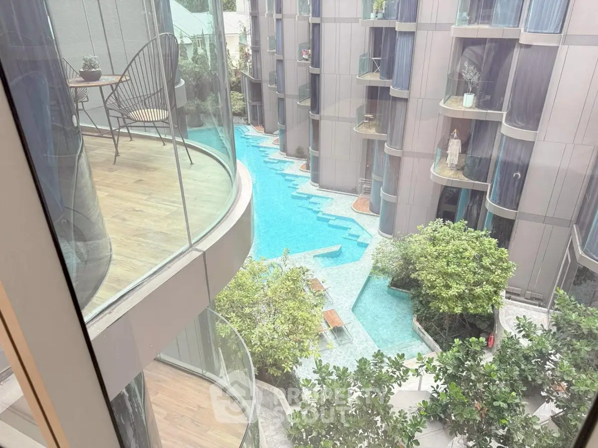 Luxurious apartment view with modern pool and lush greenery