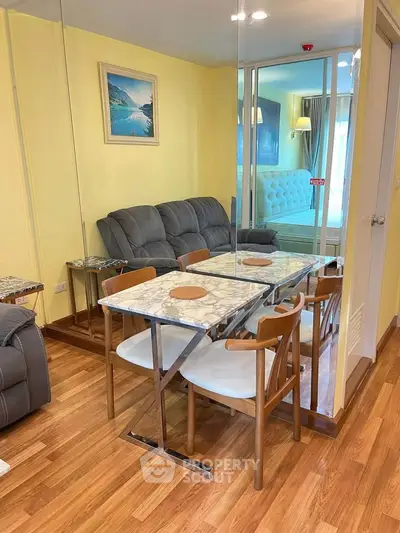 Chic modern living room with elegant dining area and cozy seating, perfect for urban living.