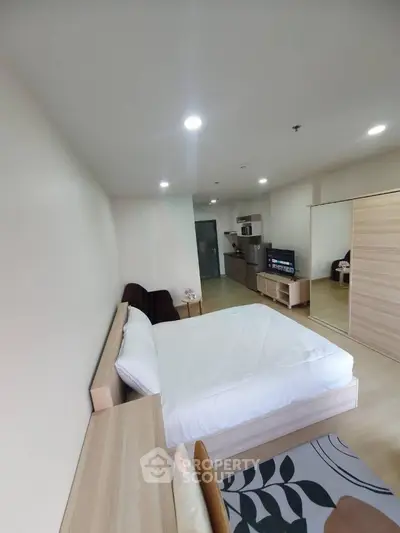 Modern studio apartment with cozy bedroom and open kitchen layout