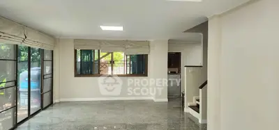 Spacious living room with large windows and natural light