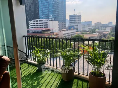 Charming balcony with lush greenery and cityscape view, perfect for relaxation and enjoying urban living.