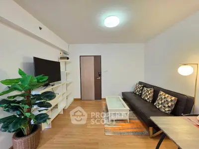 Modern living room with stylish decor, wooden flooring, and cozy seating area.