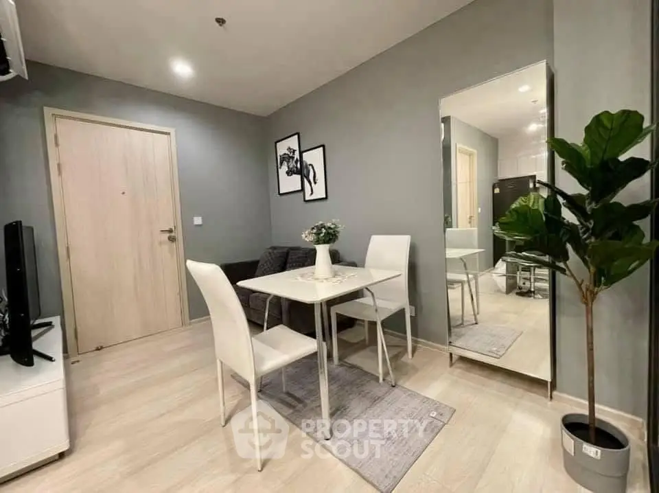 Modern dining area with sleek furniture and stylish decor in a cozy apartment setting.