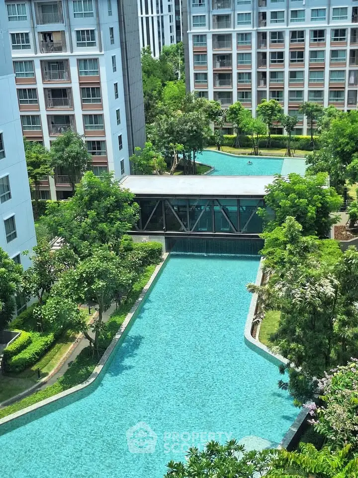 Luxurious apartment complex with stunning pool and lush gardens, offering a serene urban oasis.
