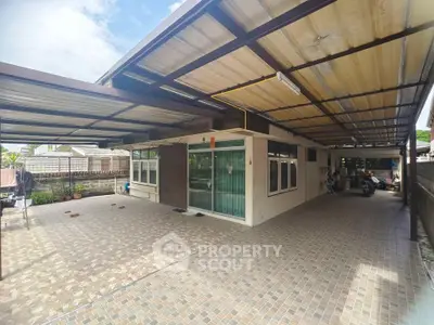 Spacious covered carport with tiled flooring in a modern residential property.