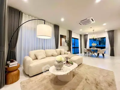 Luxurious modern living room with elegant dining area, featuring stylish furniture and ambient lighting.