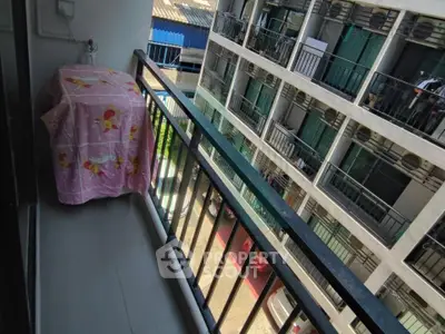 Charming balcony view in modern apartment complex with vibrant surroundings.