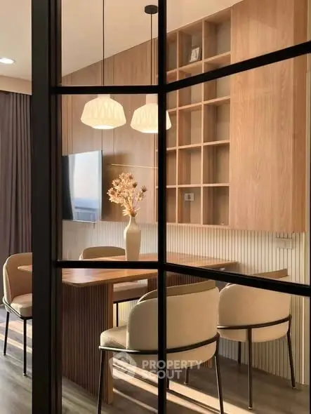 Elegant dining area with modern lighting and wooden accents