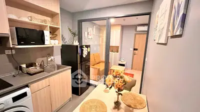 Modern kitchen with open layout and cozy dining area in stylish apartment