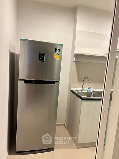 Modern kitchen with stainless steel fridge and sleek cabinetry