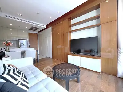 Modern living room with sleek design, open kitchen, and stylish furniture in a contemporary apartment.