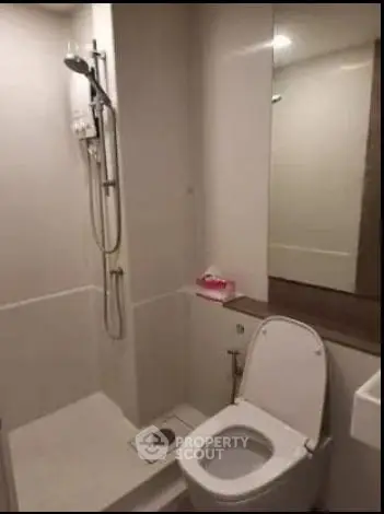 Modern bathroom with shower and toilet in compact space