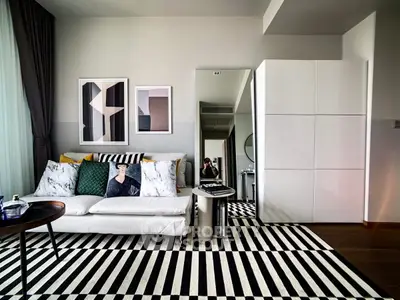 Stylish modern living room with striped rug and chic decor