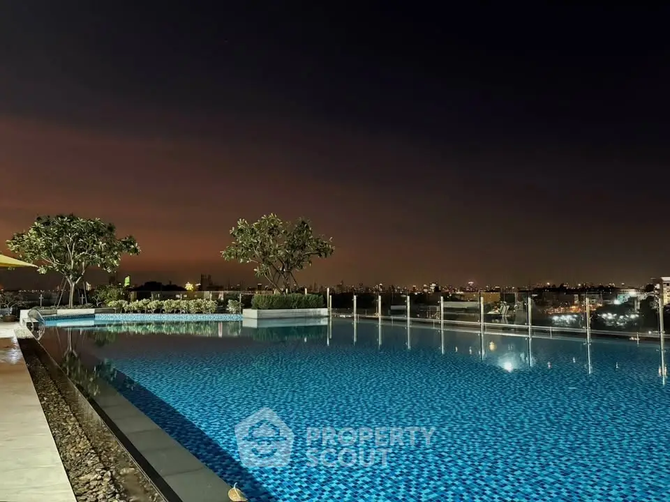 Stunning rooftop infinity pool with panoramic city views at dusk, perfect for luxury living.