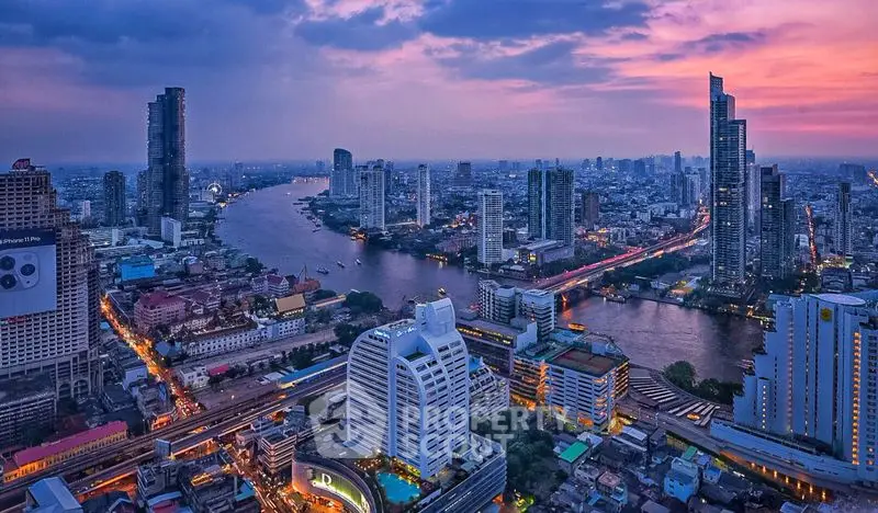 Stunning cityscape view of a vibrant urban skyline at dusk with a river winding through modern skyscrapers.