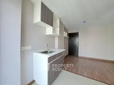 Modern minimalist kitchen with sleek cabinetry and wood flooring