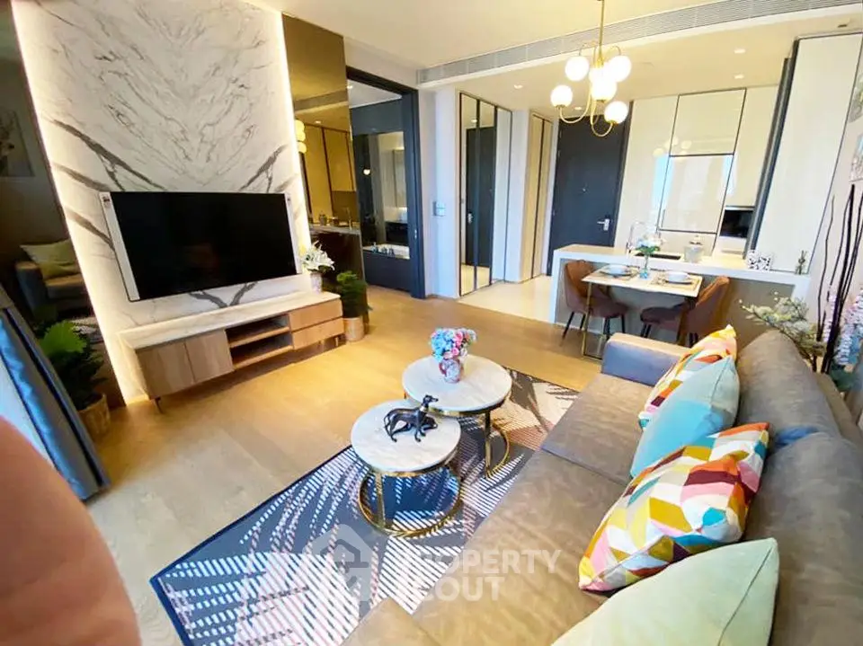 Modern living room with stylish decor and open layout, featuring a cozy seating area and elegant dining space.