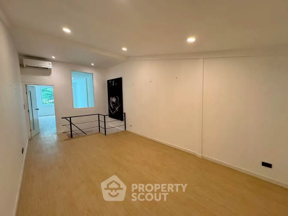 Spacious open-plan living area with modern lighting and wooden flooring, ideal for customization.