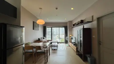 Modern living room with dining area and city view, featuring stylish furniture and natural light.