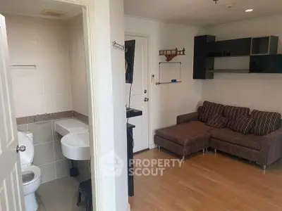 Cozy living room with adjacent bathroom in modern apartment