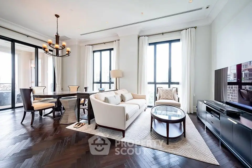 Luxurious modern living room with elegant decor and large windows offering city views.