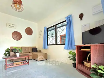 Cozy living room with modern decor, comfortable seating, and natural light.