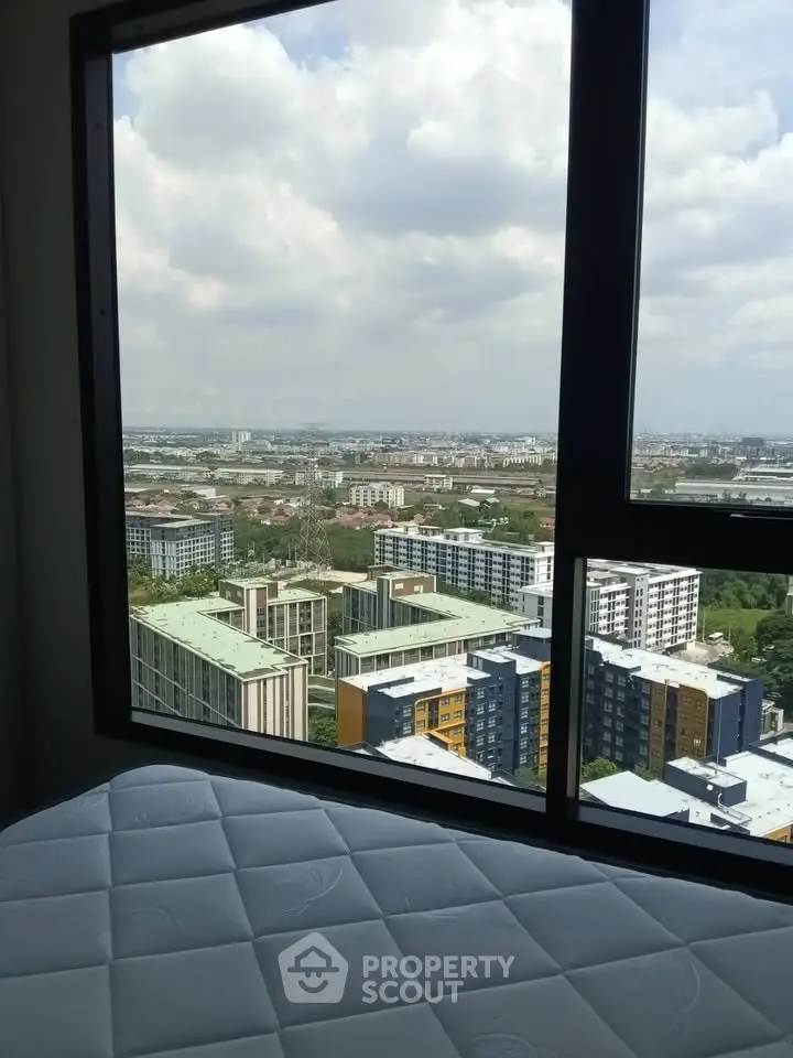Stunning cityscape view from a high-rise apartment window, showcasing modern urban living.