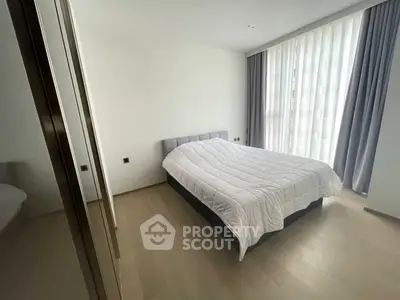 Modern bedroom with large window and minimalist decor