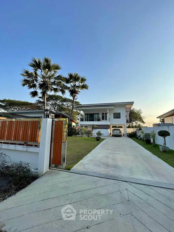 Modern two-story house with spacious driveway and lush garden