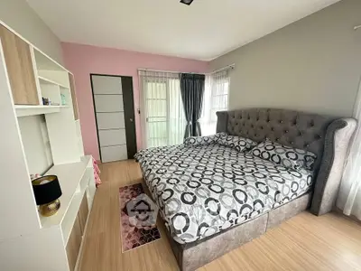 Spacious bedroom with modern decor and large bed, perfect for relaxation.