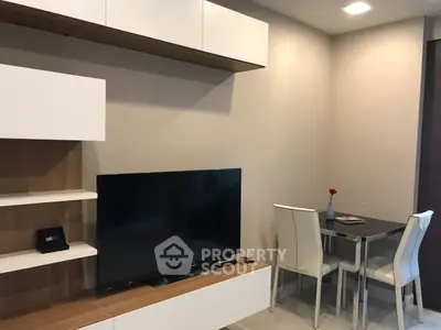 Modern living room with sleek TV unit and cozy dining area