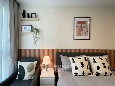 Modern bedroom with stylish decor and cozy ambiance, featuring elegant wall art and plush pillows.