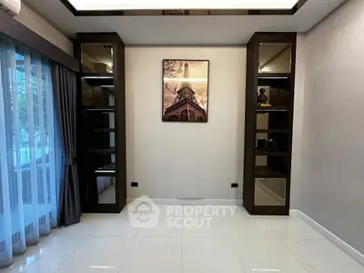 Elegant living room with modern shelving and large window, perfect for stylish urban living.