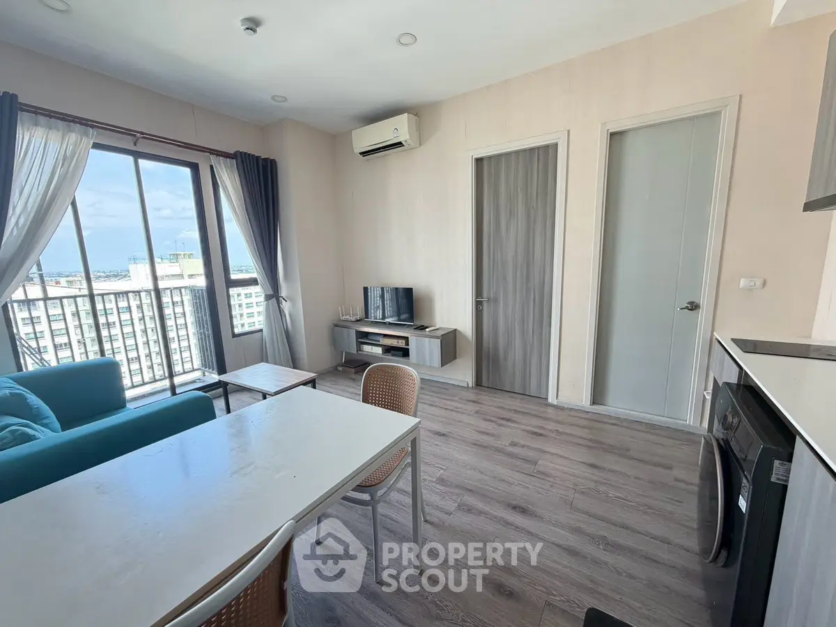 Modern living room with balcony view in high-rise apartment