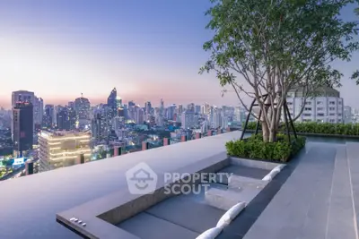 Luxurious rooftop infinity pool with stunning city skyline view at sunset.