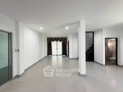 Spacious open-plan living area with modern design and ample natural light.