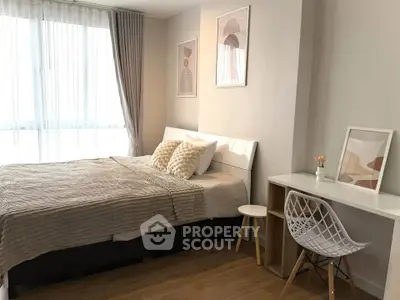 Modern bedroom with stylish decor and natural light, featuring a cozy bed and a chic workspace.