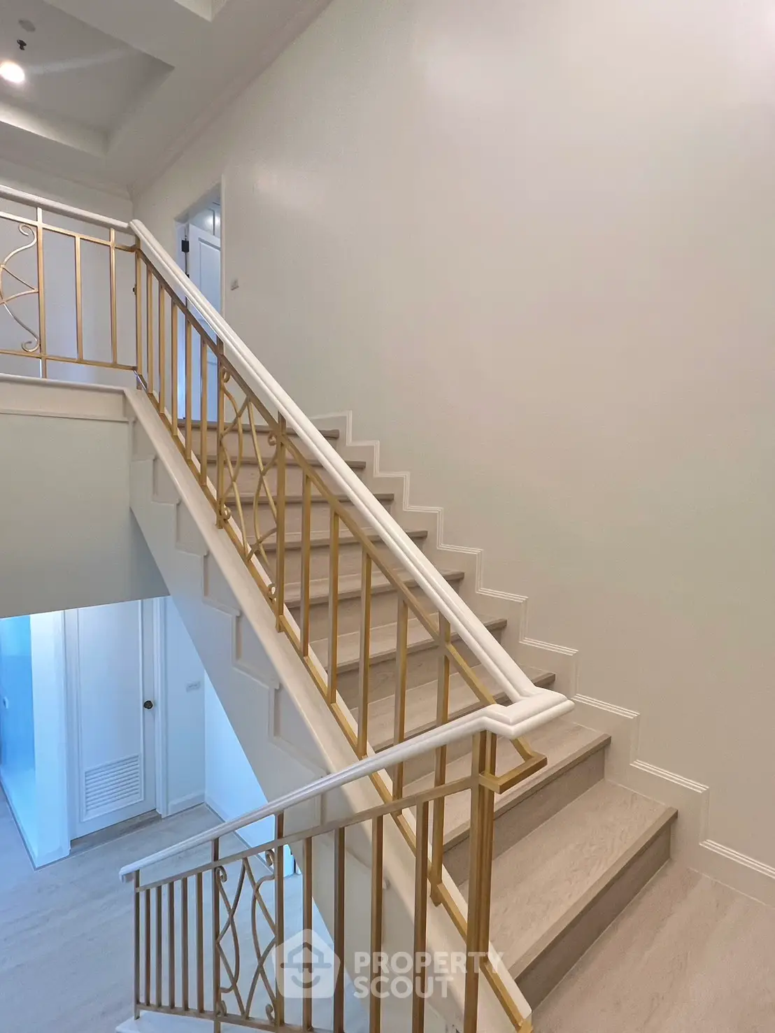 Elegant staircase with gold railings in a modern building interior