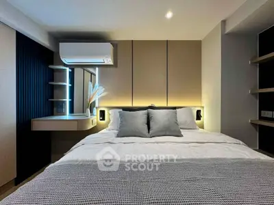 Modern bedroom with stylish lighting and cozy bedding in a contemporary apartment.