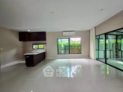 Spacious modern living room with open kitchen and large windows