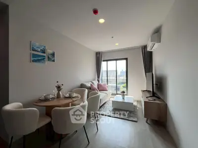 Modern living room with dining area and city view, featuring stylish decor and natural light.