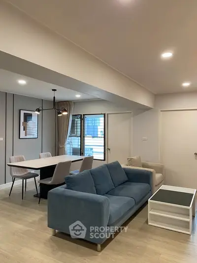 Modern living room with stylish furniture and open dining area