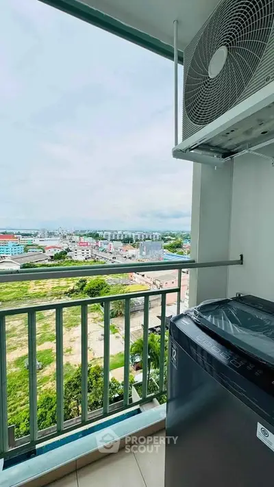 High-rise balcony with city view and outdoor washing machine setup.