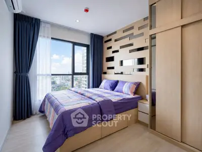 Modern bedroom with city view, featuring stylish wood paneling and large window for natural light.
