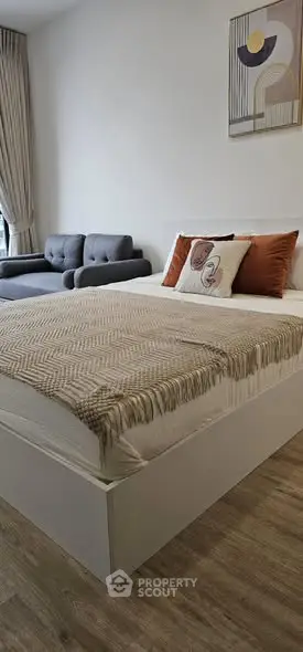 Modern bedroom with stylish decor and cozy seating area