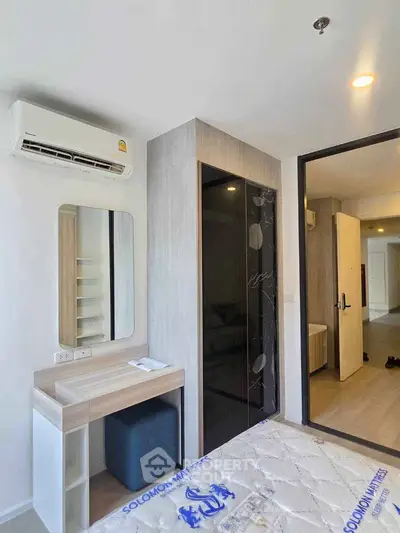 Modern bedroom with air conditioning and stylish decor in a contemporary apartment.