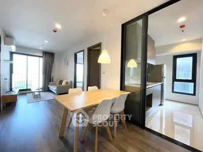Modern open-plan living room with dining area and kitchen in a stylish apartment