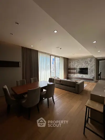 Luxurious living room with elegant dining area and large windows offering stunning city views.