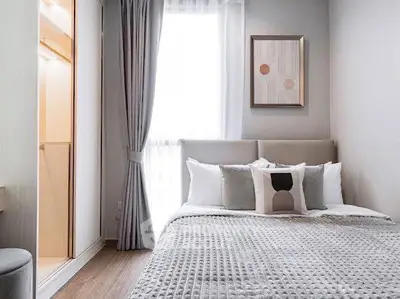 Cozy modern bedroom with stylish decor and natural light