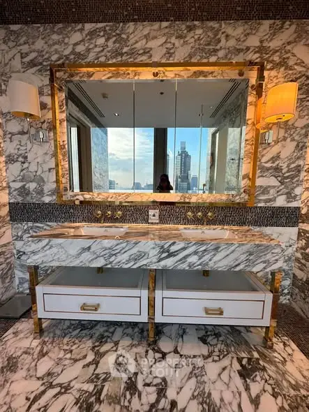 Luxurious marble bathroom with dual sinks and city view